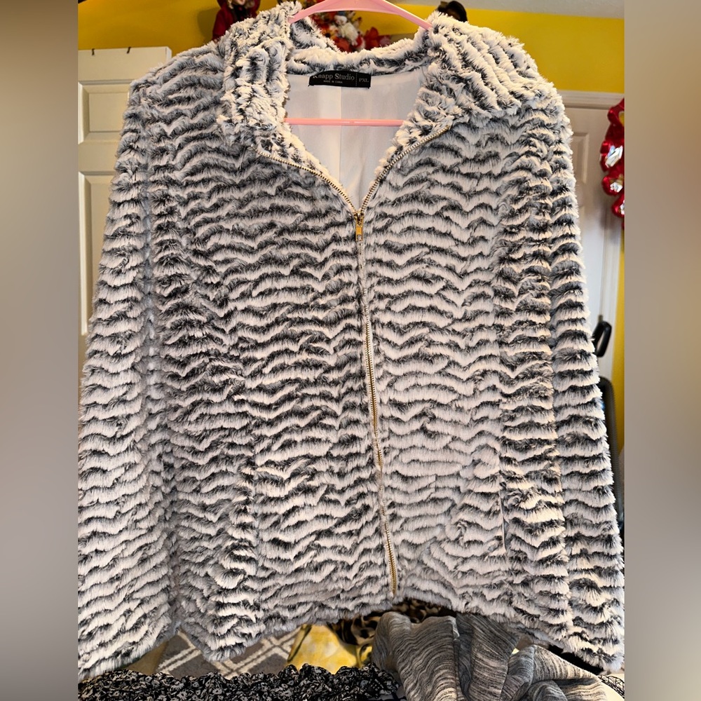 I’m selling a grey and white jacket with a gold colored zipper